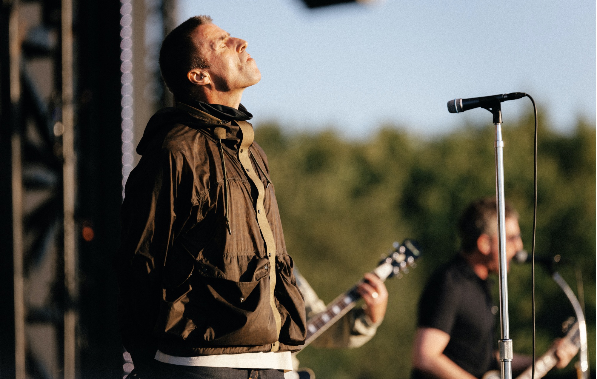 Liam Gallagher performing live on stage with Oasis at Manchester's Heaton Park