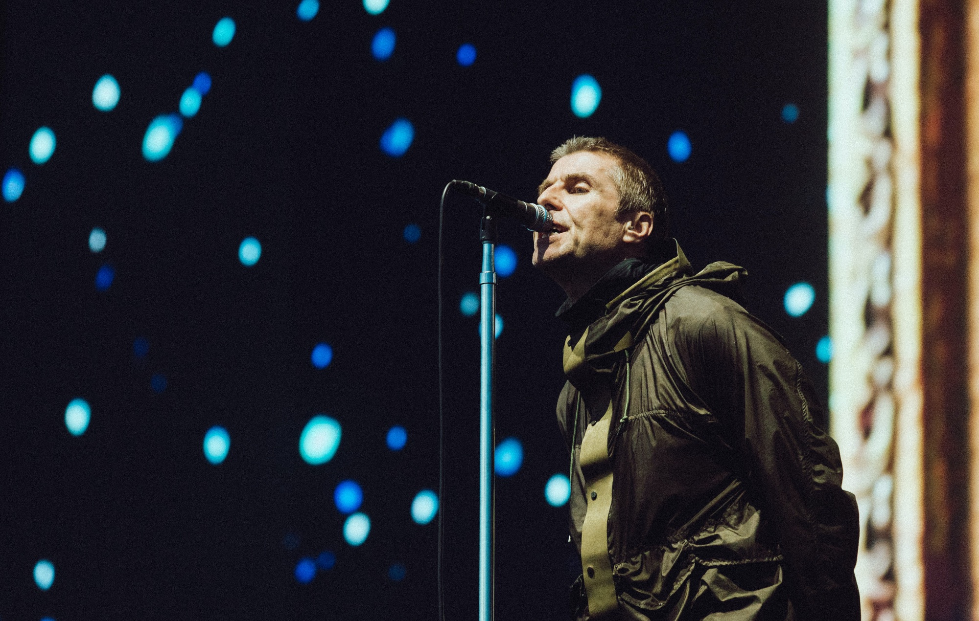 Liam Gallagher performing live on stage with Oasis at Manchester's Heaton Park